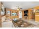 Spacious living room featuring tile floors, a ceiling fan, neutral wall color, and a cozy seating area at 530 Lakemont Nw Ave, Port Charlotte, FL 33952