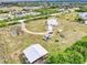 The home features a long driveway, outbuildings, several vehicles and is set on a large private lot at 6171 Swiss Blvd, Punta Gorda, FL 33982