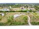 Overhead view of a property featuring a pond, barn, home, and mature trees at 6171 Swiss Blvd, Punta Gorda, FL 33982