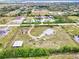 Expansive aerial view of the property showcasing the home, surrounding land, and outbuildings at 6171 Swiss Blvd, Punta Gorda, FL 33982
