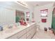 Well-lit bathroom with double sinks, ample counter space, and decorative accents at 6171 Swiss Blvd, Punta Gorda, FL 33982