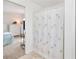 Attached bathroom with standing shower, curtain and view into the primary bedroom at 6171 Swiss Blvd, Punta Gorda, FL 33982