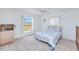 Bright bedroom featuring neutral carpet, white walls, and a window overlooking a tranquil outdoor space at 6171 Swiss Blvd, Punta Gorda, FL 33982