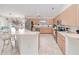 Well-equipped kitchen with light wood cabinetry, stainless steel appliances, and a breakfast bar at 6171 Swiss Blvd, Punta Gorda, FL 33982