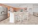 Open kitchen featuring a breakfast bar, stainless steel fridge, and seamless access to living areas at 6171 Swiss Blvd, Punta Gorda, FL 33982