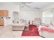 Comfortable living room with a plush sofa, recliner, and a glass-top coffee table on a red area rug at 6171 Swiss Blvd, Punta Gorda, FL 33982