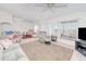 Bright and airy living room featuring neutral tones, ample seating, and natural light from large windows at 6171 Swiss Blvd, Punta Gorda, FL 33982