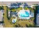 Overhead view of the community pool and hot tub area surrounded by palm trees and lounge chairs, creating a resort-like atmosphere at 6251 Cassia St, Bradenton, FL 34203