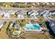 Aerial view showcasing the community pool, palm trees, and well-maintained homes in a desirable neighborhood at 6251 Cassia St, Bradenton, FL 34203