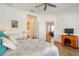 Bedroom with wood-look tile flooring, a comfy bed, and access to a bathroom, with a desk on the side at 6251 Cassia St, Bradenton, FL 34203