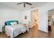 Bedroom boasting wood-look tile flooring, access to the en-suite bathroom, and a comfortable bed at 6251 Cassia St, Bradenton, FL 34203