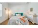 Cozy bedroom showcasing wood-look tile flooring and a dresser with elegant decor atop it at 6251 Cassia St, Bradenton, FL 34203