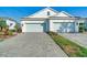Charming light-colored villa boasts a two-car garage and meticulously maintained landscaping, enhancing its curb appeal at 6251 Cassia St, Bradenton, FL 34203