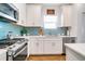 The kitchen showcases blue backsplash, stainless steel appliances, and ample counter space at 6251 Cassia St, Bradenton, FL 34203