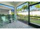 Enclosed lanai showcasing seating, a brick-paved floor, and views of the fenced backyard at 6251 Cassia St, Bradenton, FL 34203