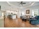 Open-concept home featuring the kitchen and living room, which has a comfortable sofa and arm chair at 6251 Cassia St, Bradenton, FL 34203