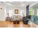 Inviting living room with a comfortable couch, accent chair, and access to a screened patio at 6251 Cassia St, Bradenton, FL 34203