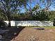 View of backyard featuring mature trees and a privacy fence at 8152 Robert St, Englewood, FL 34224