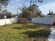 Fenced backyard with grass and some trees at 8152 Robert St, Englewood, FL 34224
