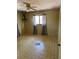 A bedroom with patterned floor and a window with curtains at 8152 Robert St, Englewood, FL 34224
