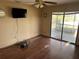 Bedroom with ceiling fan and sliding glass doors at 8152 Robert St, Englewood, FL 34224