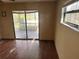 Bedroom with a sliding glass door that leads to a deck at 8152 Robert St, Englewood, FL 34224