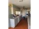 Kitchen with wood floors, gray cabinets, and stainless steel refrigerator at 8152 Robert St, Englewood, FL 34224