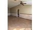 View of the living room with a ceiling fan and wood laminate flooring at 8152 Robert St, Englewood, FL 34224
