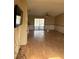 View of the living room with wood floor and light yellow paint at 8152 Robert St, Englewood, FL 34224