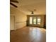 View of the living room with wood floor and light yellow paint at 8152 Robert St, Englewood, FL 34224