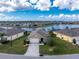 Aerial view of a single Gathering home located on a lake front property with well manicured lawns at 7049 Waterford Pkwy, Punta Gorda, FL 33950