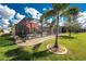 Well-manicured backyard with a screened lanai, palm trees and landscaping at 7049 Waterford Pkwy, Punta Gorda, FL 33950