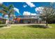 Spacious backyard featuring a screened-in lanai and lush green lawn at 7049 Waterford Pkwy, Punta Gorda, FL 33950