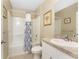 Simple bathroom featuring a shower/tub combo with patterned curtain, tile flooring, and vanity at 7049 Waterford Pkwy, Punta Gorda, FL 33950