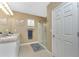 Well-lit main bathroom featuring double sinks, a walk-in shower and modern finishes at 7049 Waterford Pkwy, Punta Gorda, FL 33950