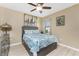 Bedroom with neutral walls, light wood floors, ceiling fan, and comfortable bed with matching furniture at 7049 Waterford Pkwy, Punta Gorda, FL 33950
