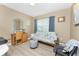 Bedroom featuring a futon, desk with chair, and a window with natural light at 7049 Waterford Pkwy, Punta Gorda, FL 33950