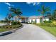 Community clubhouse featuring a circular drive, manicured landscaping, and a welcoming entrance at 7049 Waterford Pkwy, Punta Gorda, FL 33950