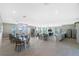 Spacious clubhouse interior with multiple seating areas, tables, and a kitchenette for community events at 7049 Waterford Pkwy, Punta Gorda, FL 33950