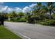 Gated entrance to the Waterford community with tropical landscaping and a glimpse of the community sign at 7049 Waterford Pkwy, Punta Gorda, FL 33950