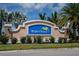 Waterford community entrance sign on a sunny day, set amongst lush green landscaping and palm trees at 7049 Waterford Pkwy, Punta Gorda, FL 33950