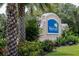 Waterford community sign framed by palm trees and colorful flower beds welcomes residents and visitors at 7049 Waterford Pkwy, Punta Gorda, FL 33950