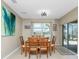 View of the dining area and table for six with a lovely view out the window at 7049 Waterford Pkwy, Punta Gorda, FL 33950