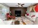 Cozy living room featuring an accent wall, ceiling fan and comfortable furniture at 7049 Waterford Pkwy, Punta Gorda, FL 33950