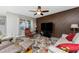 Relaxing living room space featuring a ceiling fan, modern decor and natural light at 7049 Waterford Pkwy, Punta Gorda, FL 33950