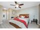 Bright main bedroom features a wood accent wall and adjoining ensuite bathroom at 7049 Waterford Pkwy, Punta Gorda, FL 33950