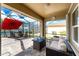 Screened patio overlooking a tranquil lake, with outdoor seating and stylish furniture arrangement at 7049 Waterford Pkwy, Punta Gorda, FL 33950