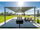 Community picnic area with picnic tables, and a grill, perfect for outdoor gatherings and relaxation at 7049 Waterford Pkwy, Punta Gorda, FL 33950