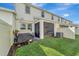 Exterior view of the backyard showing a screened patio, green lawn, and privacy fence at 11637 Woodleaf Dr # 11637, Bradenton, FL 34211