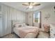 Charming bedroom featuring a queen bed, a window and a ceiling fan with neutral decorations at 11637 Woodleaf Dr # 11637, Bradenton, FL 34211